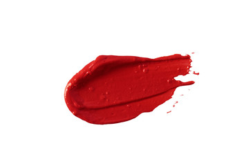 Red lipstick smear smudge swatch isolated on white background. Makeup texture. Bright color cosmetic product brush stroke swipe sample