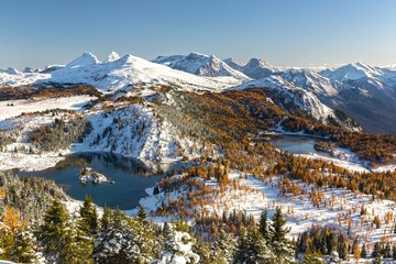 Scenic Banff National Park Mountain Landscape after Early Autumn Snow in Canadian Rocky Mountains with Golden Larches, Blue Lakes and Distant Snowcapped Mountain Peaks on Horizon - obrazy, fototapety, plakaty