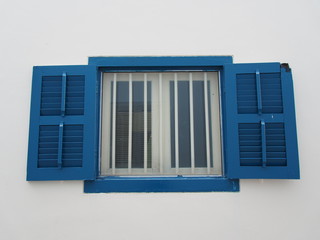 window with blue shutters
