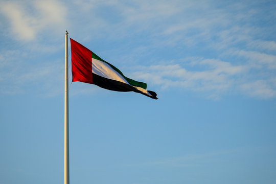 uae flag waving against cloudy sky , uae flag day, united arab emirates national day 