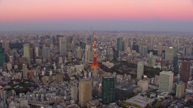 Tokyo, Japan circa-2018.  Flying over Tokyo Tower at sunset.  Shot from helicopter with RED camera.