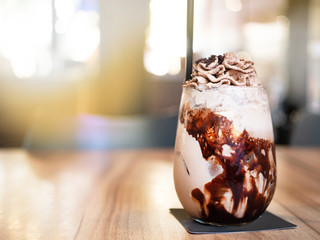 chocolate frappe with whip cream above. put on the wooden table.