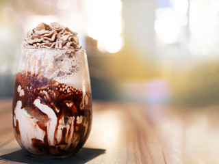 chocolate frappe with whip cream above. put on the wooden table.