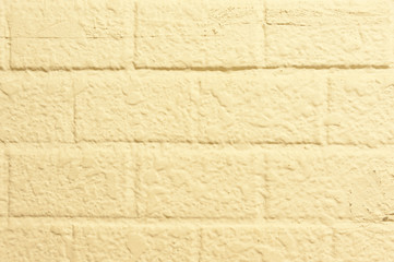 Detailed close-up of beige brick wall for use in wallpaper, texture, design, pattern, backgrounds, etc.