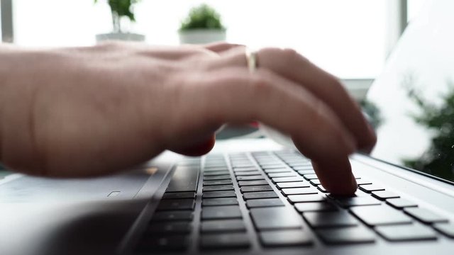 Male arms in suit typing on silver keyboard using computer pc at office workplace closeup. Accountant finger job modern lifestyle web search assistant enter account login password and note credential