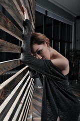 Girl posing in a photo studio. In black tights, boots and a long skirt. Modern choreography, dance.