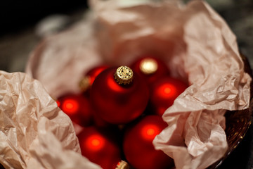 Christmas red balls collected in a wrap paper as a gift , festive decoration background