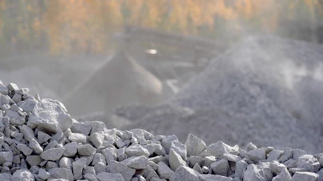 Industrial background - crusher stone crushing machine at the quarry of a mining and processing plant for crushed stone