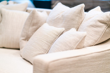 Fototapeta na wymiar close up of soft fabric pillow decoration on beautiful sofa in living room home design concept