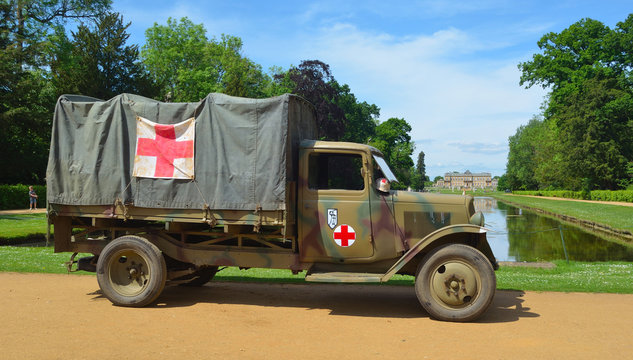  Vintage Second World War truck with red cross signs  parked  with Wrest Park House in background