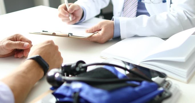 Doctor talks to patient and fills in medical history. Signs an agreement for surgery and organ donorship donation