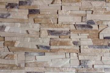 Natural stone wall in the house. Background, stone lined with granite walls. sandstone. stone wall background. Facing stone