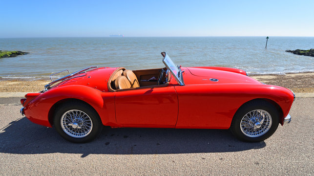 Classic Red MG A Motor Car Parked on Seafront Promenade.