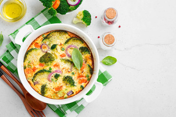 Frittata or casserole with broccoli and vegetables in baking dish. Vegetarian recipe.