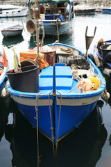 Fototapeta na wymiar Old fishing boat with tackle in Italy