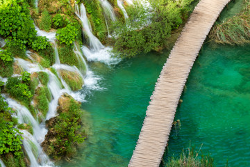 Rushing pure fresh water cascades down the natural barriers into the azure colored Lake Kaluđerovac at the Plitvice Lakes National Park in Croatia