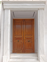 contemporary elegant house entrance solid wood door and white marble walls