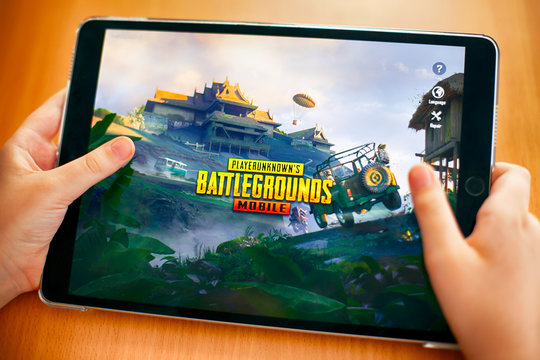 Tambov, Russian Federation - November 23, 2018 Teenager going to play PlayerUnknown's Battlegrounds (PUBG) Mobile mobile game on iPad