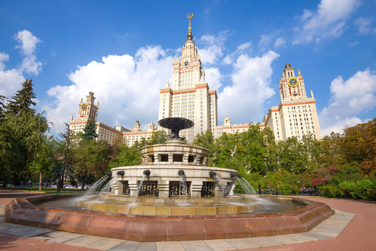 Fountain in the background of the main building of Moscow State University on a sunny August day