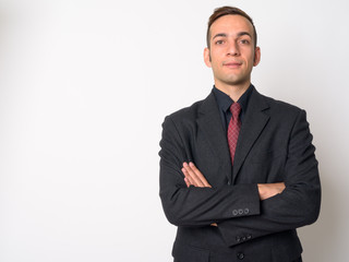 Young Persian businessman in suit with arms crossed