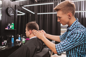 Mature man getting a new haircut at the barbershop