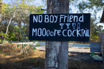 Humorous sign nailed to tree