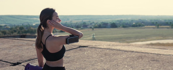 A young slim athletic girl in sportswear with snakeskin prints performs a set of exercises. Fitness...
