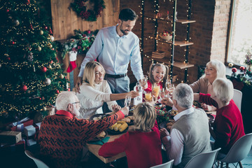 Happy holidays. Photo of full family eight members gathering sit dinner table telling x-mas toasts...