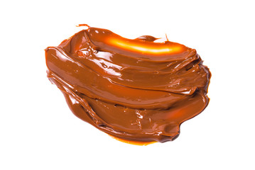 Melted tasty caramel splashes isolated on white background.