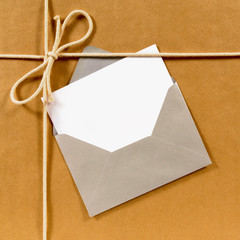 Brown paper parcel with silver envelope