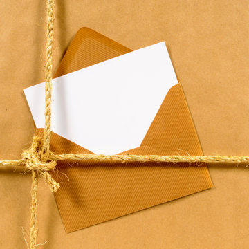 Brown paper parcel with envelope