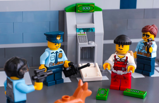 Tambov, Russian Federation - June 03, 2017 Lego policemen arrested thief who hack ATM. Studio shot.