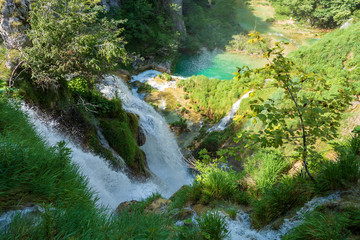 Stunning view of thunderous water masses rushing over the edge of a cliff at the Plitvice Lakes National Park, Plitvička Jezera, Croatia