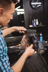 Mature man getting a new haircut at the barbershop