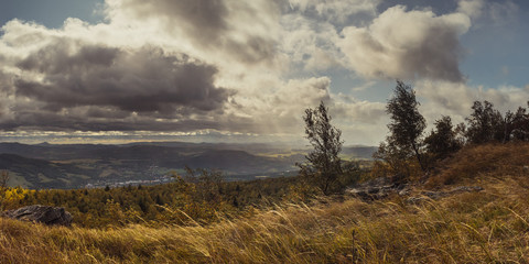 Autumn windy landscape - view of valley and Central Bohemian Highlands from table mountain Decinsky...