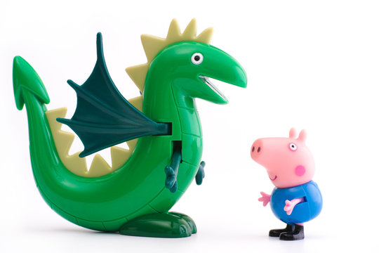 Tambov, Russian Federation - December 16, 2015: George Pig toy character with green dinosaur on white background. Studio shot.