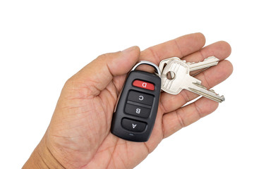 hand holding car key isolated on white