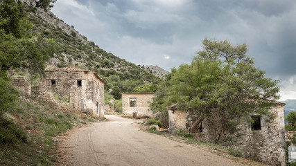 Fototapeta na wymiar road through abandoned earthquake village Palia Plagia in Greece, with ruined houses