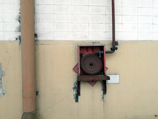 Old Red cabinet and large Orange rubber hose is used for connecting fire hose.Because it is damaged, unusable Need to make new adjustments to return 