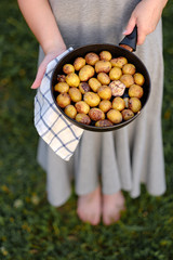 girl holding a pan with fried potatoes 