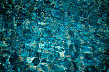 Water in swimming pool with sun reflection   