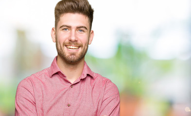 Young handsome business casual man happy face smiling with crossed arms looking at the camera. Positive person.
