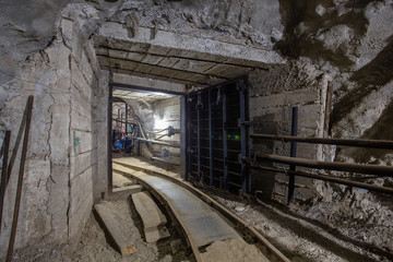 Fototapeta na wymiar Underground mine ore shaft tunnel drift with rails underground