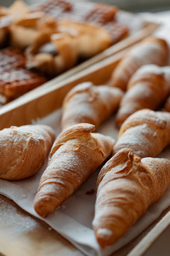 Many croissants on a wooden tray. bakery concept