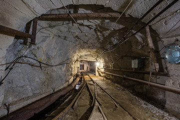 Fototapeta na wymiar Gold mine ore shaft tunnel with rails