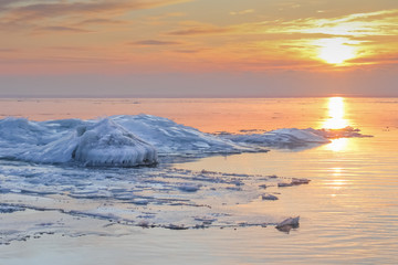 Ridges on the frozen Baltic sea in dramatic sunset in wintertime