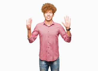 Young handsome business man with afro hair showing and pointing up with fingers number nine while...