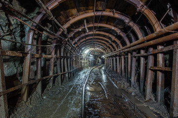 Fototapeta premium Gold mine ore shaft tunnel with rails