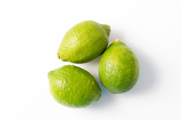 fresh green limes on a white background