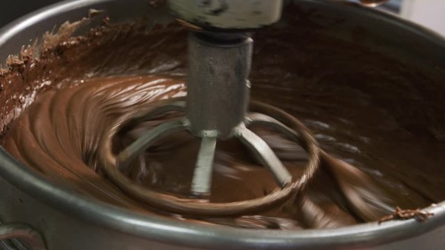 Mixing ingredients for chocolate fudge at candy factory